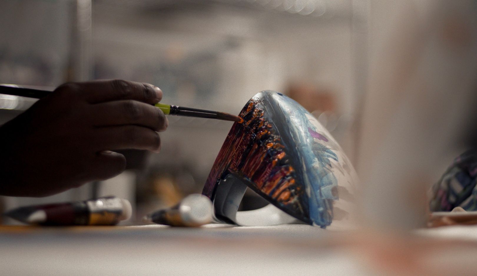 Nelson Makamo at work: The artist paints the side mirror of his Porsche 911 Carrera at his studio in Johannesburg.