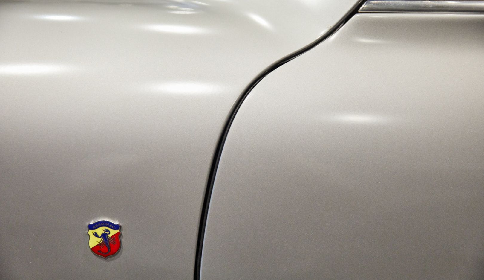 The Italian-Austrian car builder Carlo Abarth was involved in creating the race car. His crest adorns the aluminum body.