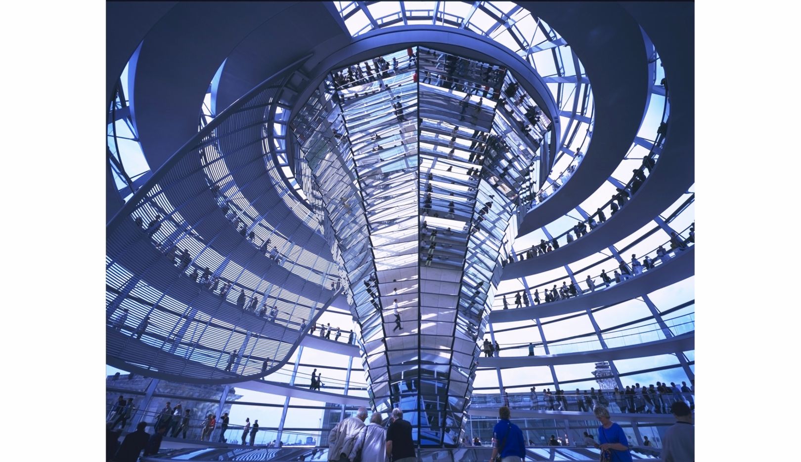 In 1993, Lord Norman Foster won the competition to reconstruct the Reichstag building in Berlin. Visitors can travel up to its glass dome and look down into the assembly hall below. At the centre of the dome, a funnel-shaped ‘light-sculptor’ with 360 mirrors reflects and directs natural light into the area. Photo: Nigel Young / Foster + Partners