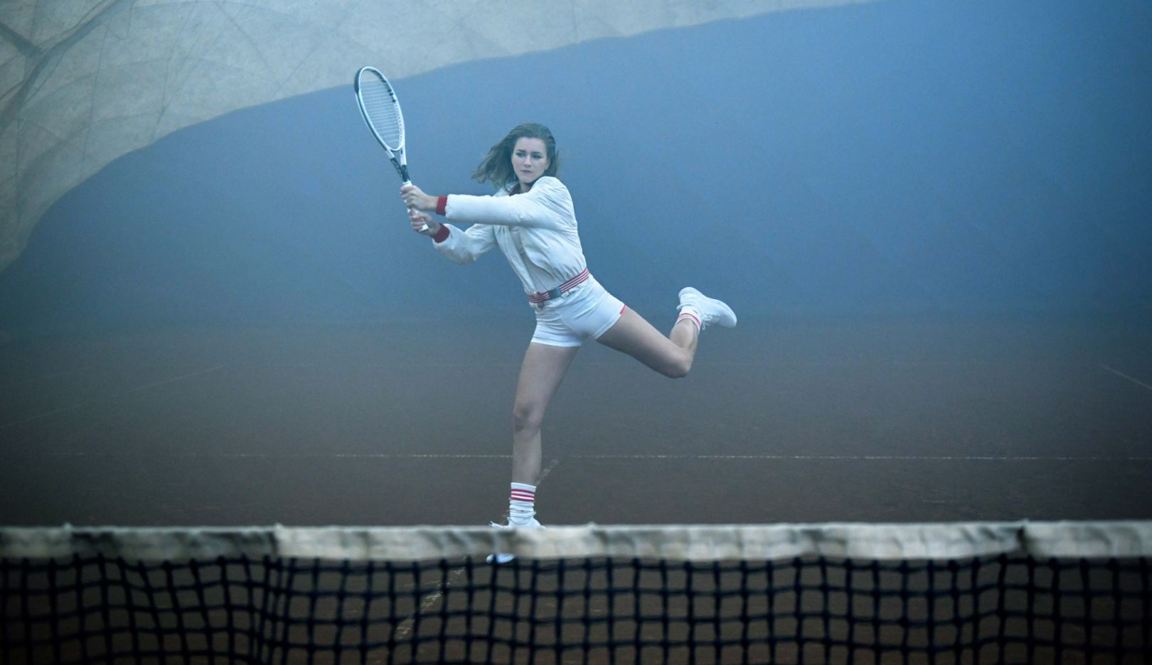 Karolína Muchová at the Tenis Cibulka club in Prague. “These old tennis bubbles have an almost futuristic feel about them. They look like space stations to me,” says Radka Leitmeritz. “I had fog pumped into the bubble for this picture. It created a mysterious, cinematic atmosphere that makes it feel like you’re all alone there – on a mission like David Bowie’s Major Tom. Karolína looks like she’s playing in her own dome in a different world.”  