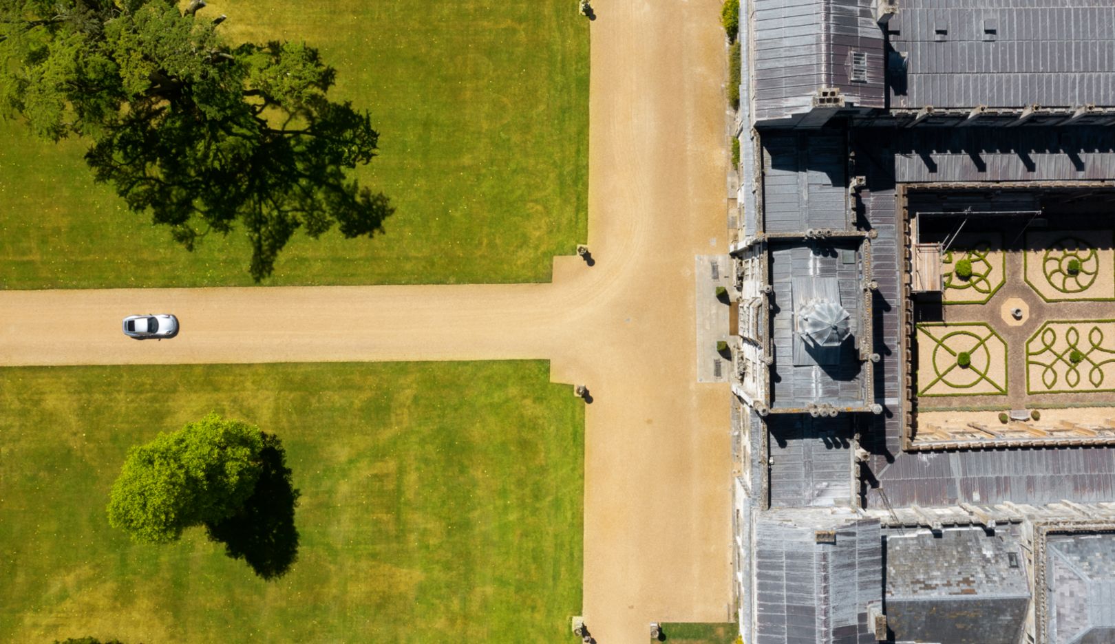 A drone shot shows the immaculately kept courtyard at the center of the stately home.