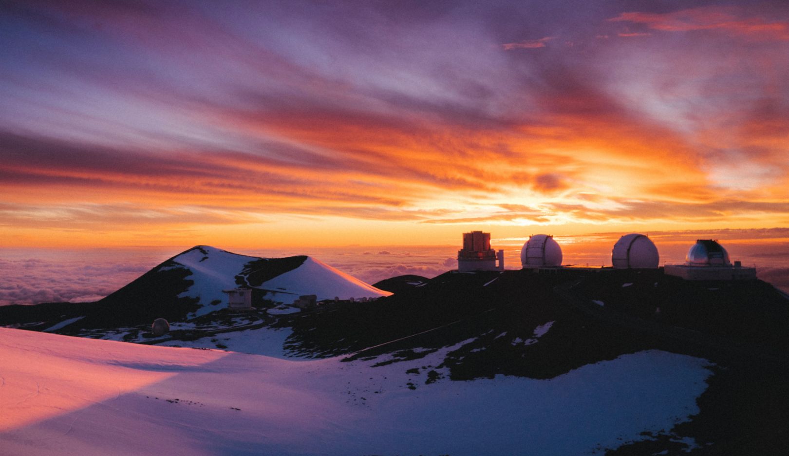 站在海拔 4,200 公尺火山顶上欣赏日出。茂纳凯亚山天文台是当今最重要的天文设施之一。