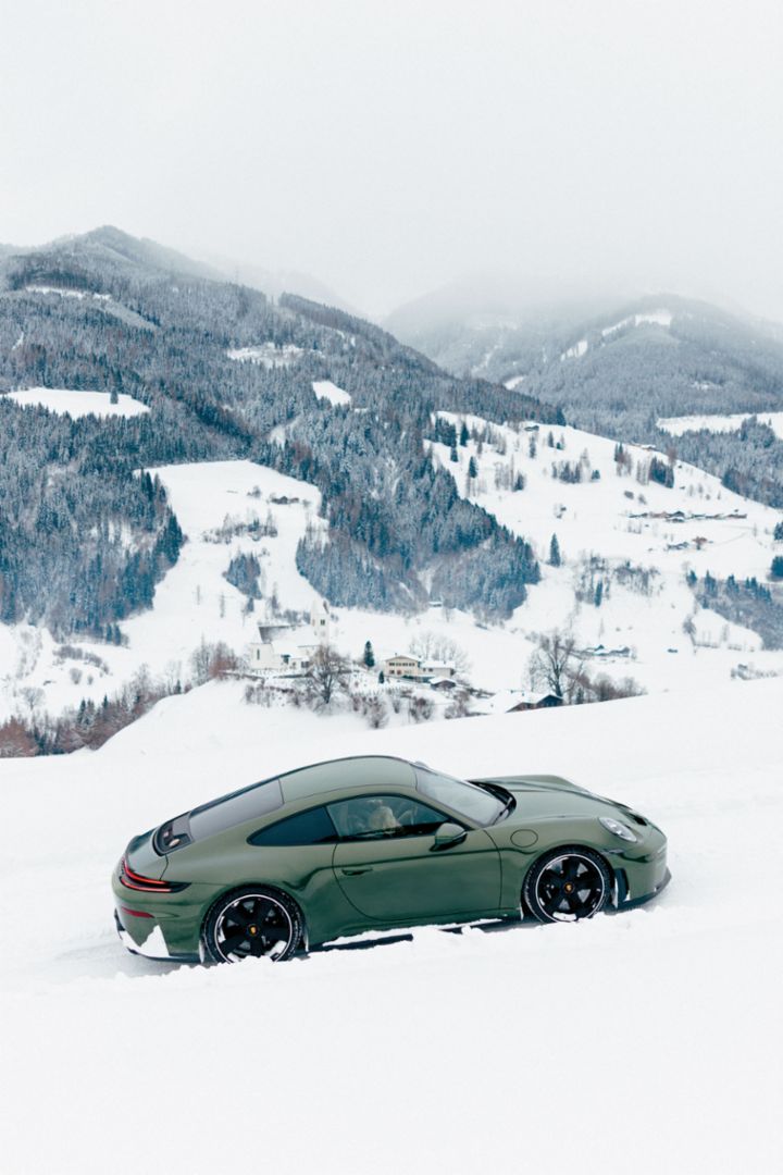 A young woman sits relaxed in a boat, wearing black Porsche Design sunglasses and a black jacket, looking into the distance. 